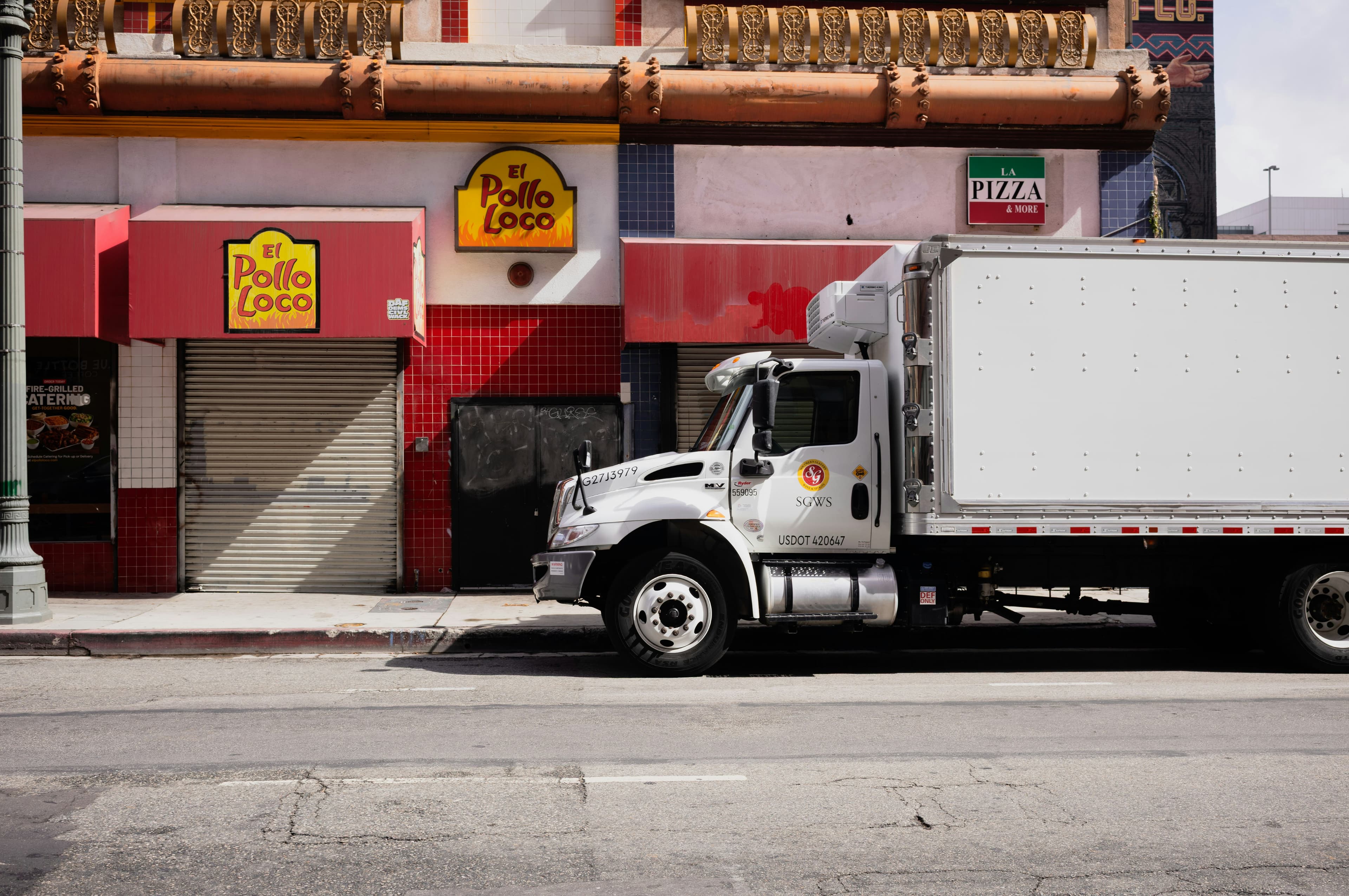 Supermarket receiving dock and chilled goods—representing retail meat and poultry QA in the UAE.